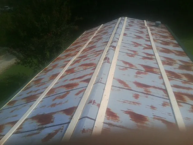Rusted metal roof panels with new wood purlins before replacement — Storm Damage Roof Repair in Amity by Roofing Brothers