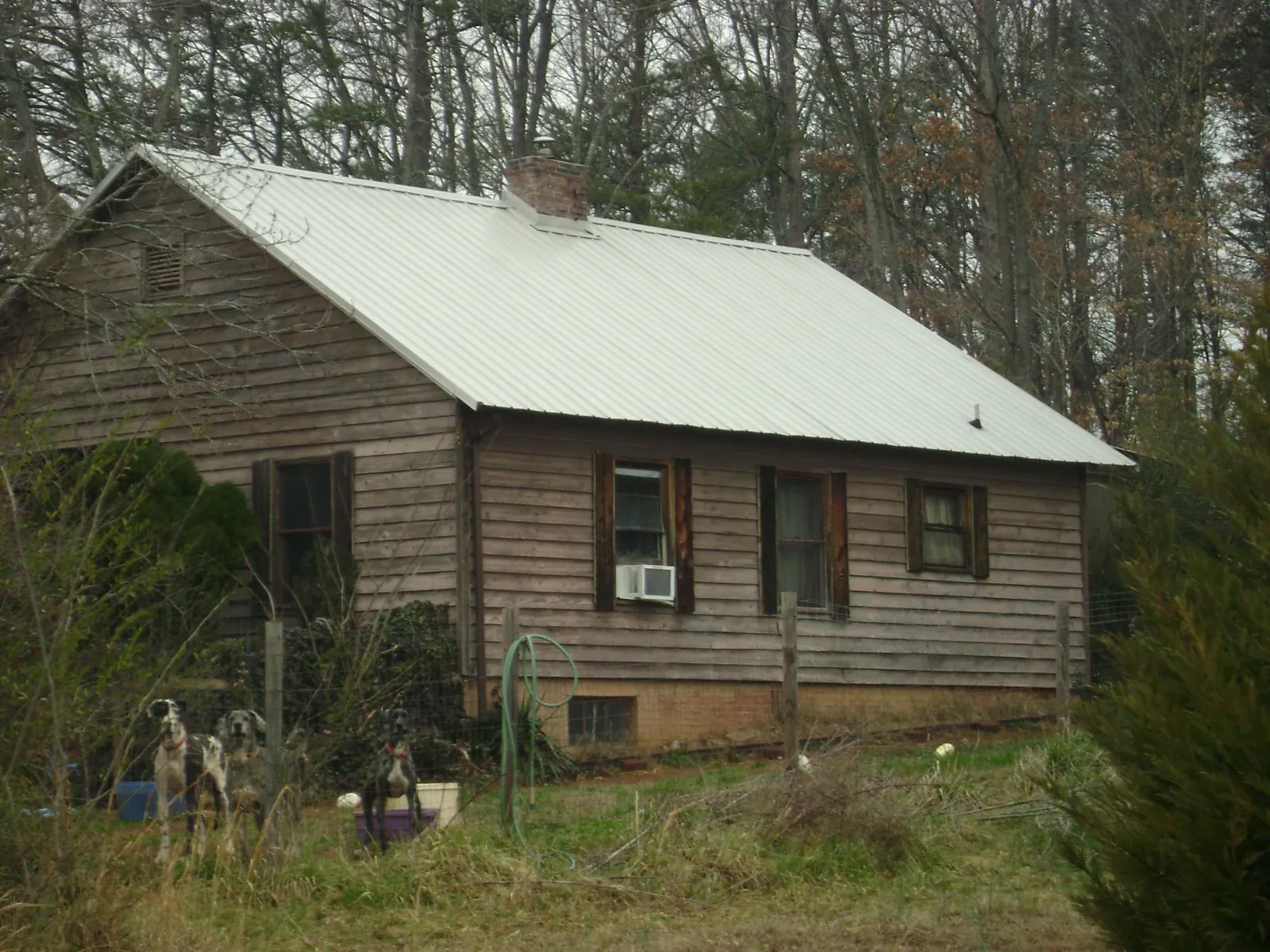 White metal roof on an old wood sided farmhouse, from a Metal Roof Installation job in Amity
